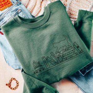 book sweatshirt embroidered sweater for cat lovers cat on bookshelf cozy reading sweatshirt book club bookworm bookish merch cat sweatshirt 1.jpeg