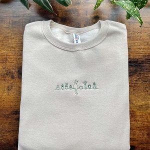 cat sitting on a shelf with plants embroidered sweatshirt 2d crewneck sweatshirt for men women sws2915 1.jpeg