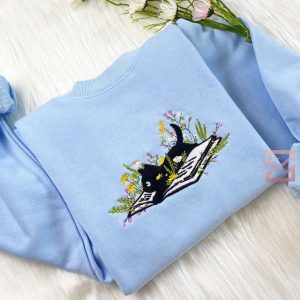 cute cat lying on book with flower embroidered sweatshirt flower with cat embroidered hoodie book lover sweater crew neck sweatshirt.jpeg